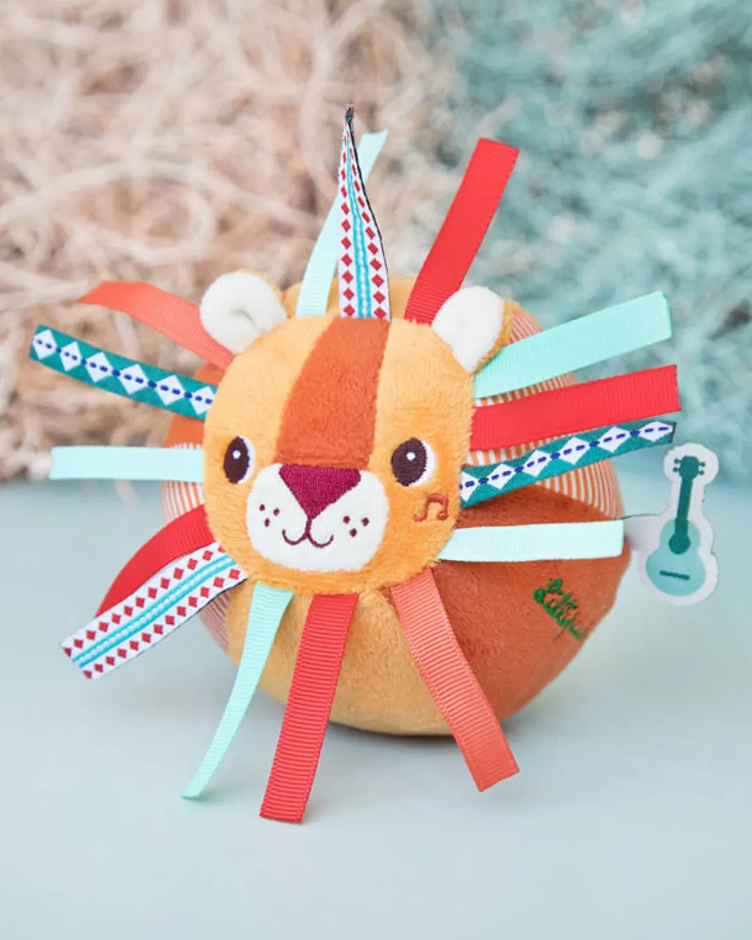 Lilliputiens - piłeczka sensoryczna z dzwoneczkiem i wypustkami Lew Jack Lilliputiens - piłeczka sensoryczna z dzwoneczkiem i wypustkami Lew Jack